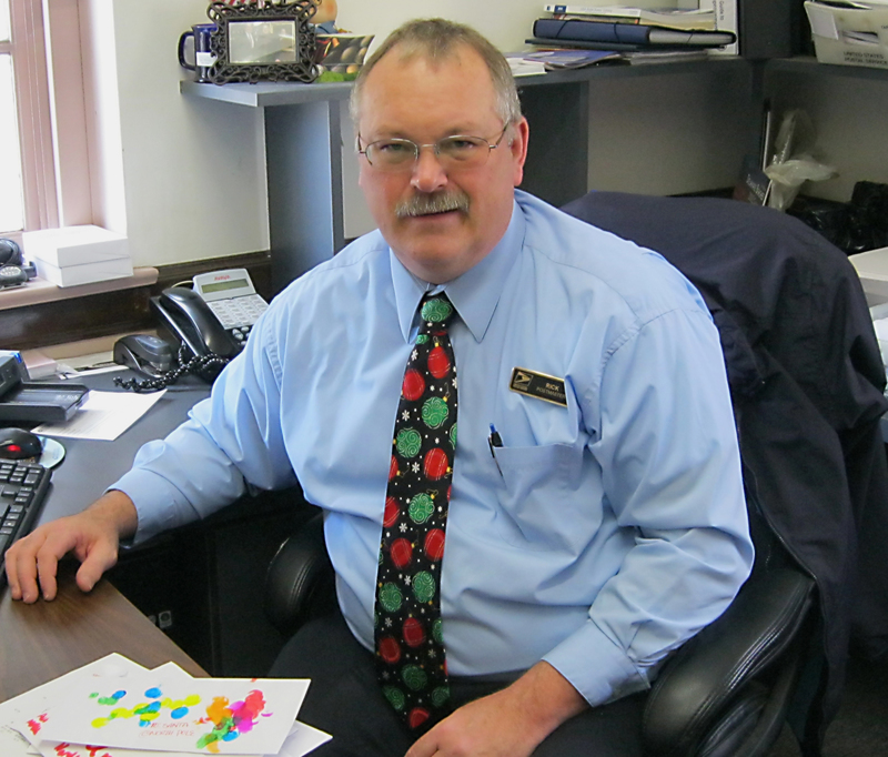 Rehoboth Beach Postmaster Rick DeWitt sits with some letters to Santa from area children. DeWitt helps Santa out by sending a personal reply to each letter. BY RACHEL SWICK MAVITY